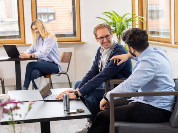 Des gens en train de discuter dans un bureau.
